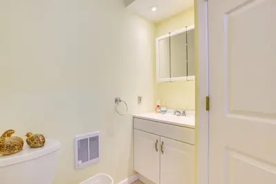 a white bathroom with a sink and a toilet at Hike, Ski and Golf Water-View Lake Winola Retreat! in Factoryville