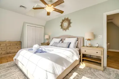 a bedroom with a white bed and a ceiling fan at Scanton Area Retreat Drive to Montage and Elk Mtn! in Factoryville