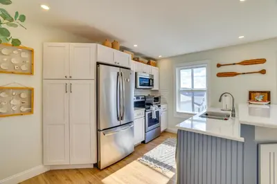 a kitchen with white cabinets and a stainless steel refrigerator at Scanton Area Retreat Drive to Montage and Elk Mtn! in Factoryville