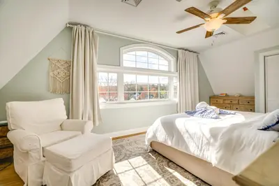 a bedroom with a bed and a chair and a window at Scanton Area Retreat Drive to Montage and Elk Mtn! in Factoryville