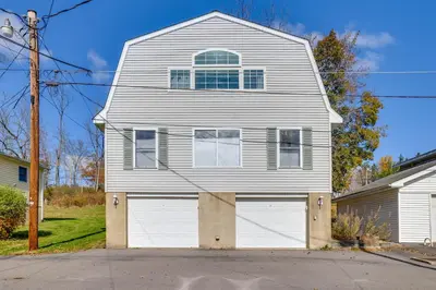 a white house with a garage at Scanton Area Retreat Drive to Montage and Elk Mtn! in Factoryville