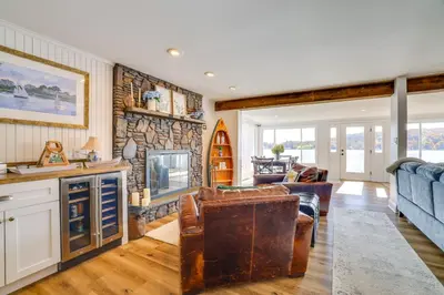 a living room with a stone wall at Scenic Waterfront Home with Dock on Lake Winola! in Factoryville