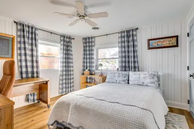 a bedroom with a bed and a ceiling fan at Scenic Waterfront Home with Dock on Lake Winola! in Factoryville
