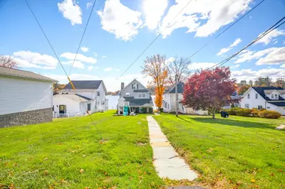 a street in a residential neighborhood with houses at Scenic Waterfront Home with Dock on Lake Winola! in Factoryville