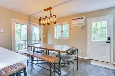a dining room with a wooden table and chairs at 6 Mi to Bushkill Falls Secluded Home with Game Room in East Stroudsburg
