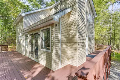 a home with a large deck on a house at 6 Mi to Bushkill Falls Secluded Home with Game Room in East Stroudsburg