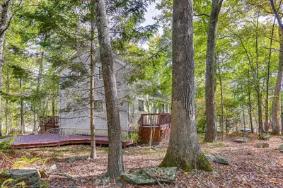 a house in the woods with trees at 6 Mi to Bushkill Falls Secluded Home with Game Room in East Stroudsburg