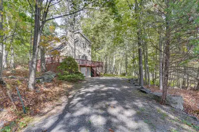 an empty road leading to a house in the woods at 6 Mi to Bushkill Falls Secluded Home with Game Room in East Stroudsburg