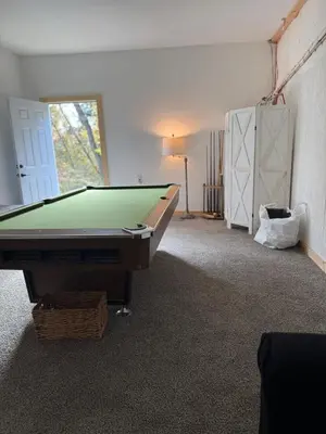 a room with a pool table in a room at Rest in Wellsville