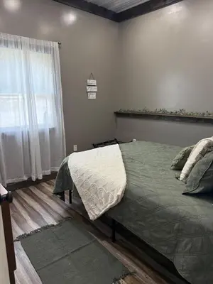 a bedroom with a bed and a window at Rest in Wellsville