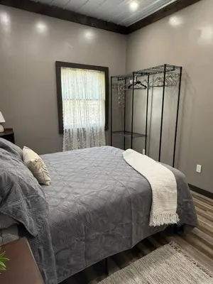 a bedroom with a bed and a window at Rest in Wellsville