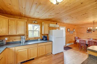 a kitchen with a refrigerator and a dining room at Secluded Retreat near Ski Resorts, Hot Tub, BBQ in Blakeslee