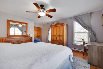a bedroom with a white bed and a ceiling fan at Secluded Retreat near Ski Resorts, Hot Tub, BBQ in Blakeslee