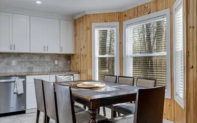 a dining room with a table and chairs in a kitchen at Lake Area 6BR Pet friendly home in Poconos - Your Pocono Retreat in Thornhurst