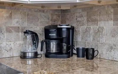 a coffee maker and coffee cups on a counter at Lake Area 6BR Pet friendly home in Poconos - Your Pocono Retreat in Thornhurst