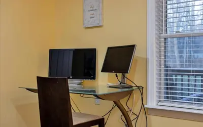 a desk with a computer and a monitor on it at Lake Area 6BR Pet friendly home in Poconos - Your Pocono Retreat in Thornhurst