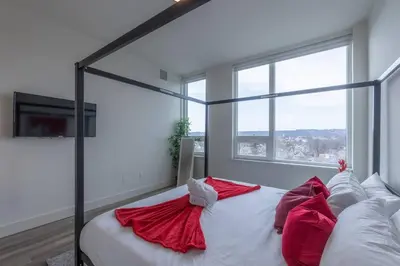 a bedroom with a bed with red pillows on it at Smoked Amber Stay, Free Parking, Sleep 5, 20 percent OFF in East Orange