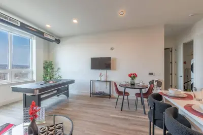 a living room with a ping pong table and chairs at Smoked Amber Stay, Free Parking, Sleep 5, 20 percent OFF in East Orange