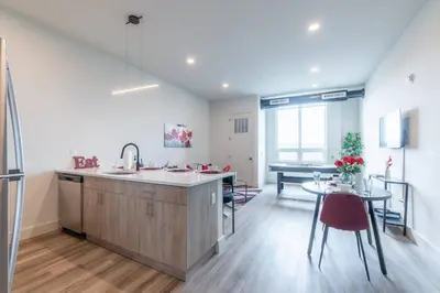 a kitchen with a sink and a table and a dining room at Smoked Amber Stay, Free Parking, Sleep 5, 20 percent OFF in East Orange