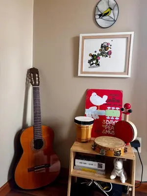 a guitar is sitting next to a table with a shelf at Cozy Creek House in Forestburgh