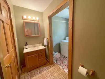 a bathroom with a sink and a mirror at Cozy Creek House in Forestburgh