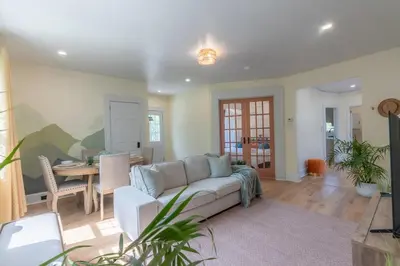 a living room with a couch and a dining room at Zen Den With King Bed and Very Close to Airport in Newark