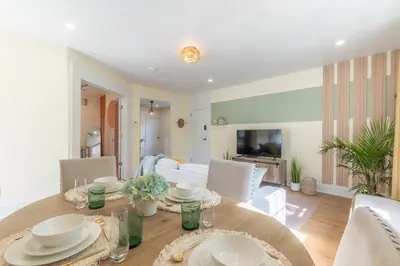 a dining room and living room with a table and chairs at Zen Den With King Bed and Very Close to Airport in Newark