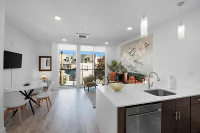 a kitchen and living room with a table and chairs at Modern 1BR Escape - Balcony Gym Wi-Fi in Philadelphia