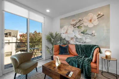 a living room with a couch and a large window at Modern 1BR Escape - Balcony Gym Wi-Fi in Philadelphia