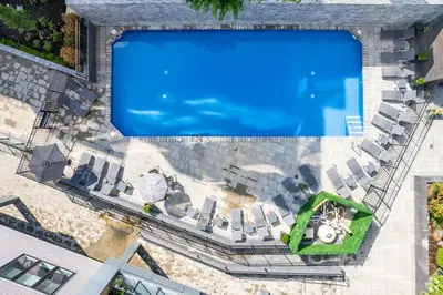 an overhead view of a swimming pool with lounge chairs at Modern 1BR Escape - Balcony Gym Wi-Fi in Philadelphia