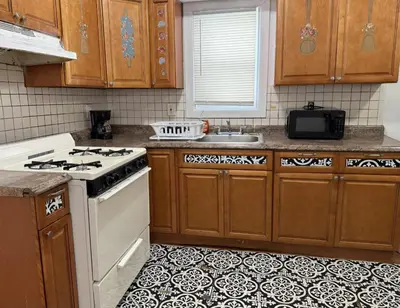 a kitchen with a white stove and a sink at Private house with 4 bedrooms 2 bathrooms, NYC direct bus 1 block away, MetLife Stadium FIFA World Cup 30 minutes away in Perth Amboy