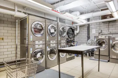 a laundry room with a bunch of washing machines at Blueground Murray Hill fitness center nr Bryant Park NYC-1939 in New York