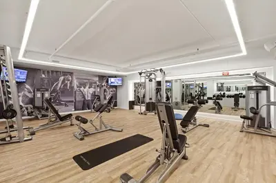 a gym with several treadmills and exercise bikes at Blueground Chelsea fitness center nr Madison Square Park NYC-390 in New York