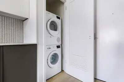 a laundry room with a washer and dryer at Blueground Chelsea rooftop pool nr High Line NYC-2145 in New York