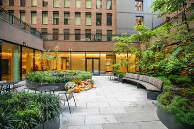 a courtyard in a building with benches and plants at Blueground Chelsea rooftop pool nr High Line NYC-2145 in New York