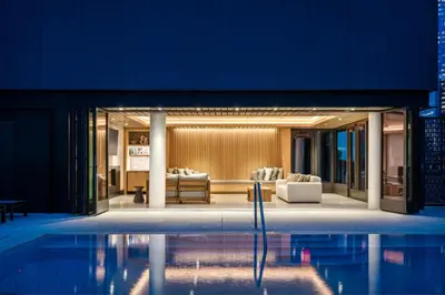 a building with a pool in front of it at Blueground Chelsea pool nr The Vessel NYC-2144 in New York