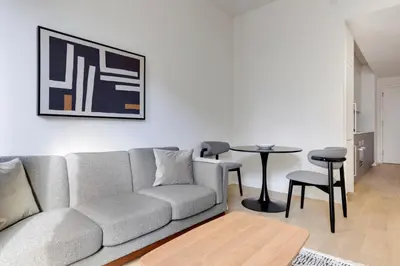a living room with a couch and a table at Blueground Chelsea pool nr The Vessel NYC-2144 in New York