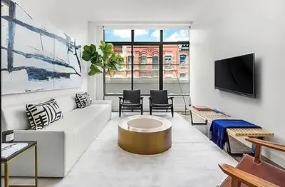 a living room with a white couch and a tv at Residence Heritage Terrace Dreaming in New York