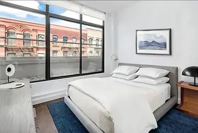a bedroom with a large white bed and a large window at Residence Heritage Terrace Dreaming in New York