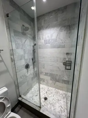 a shower with a glass door in a bathroom at Residence Heritage Terrace Dreaming in New York