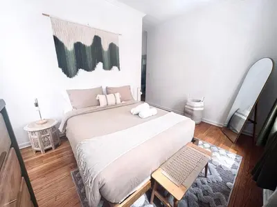 a bedroom with a large bed with white sheets at Upper East Side 2Bed Dream in New York