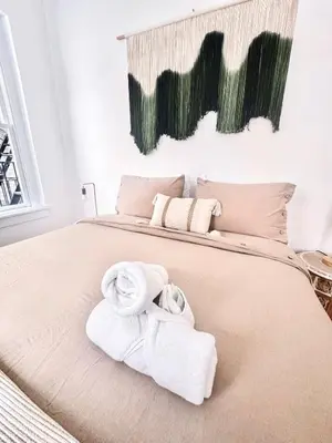 a bedroom with a bed with towels on it at Upper East Side 2Bed Dream in New York