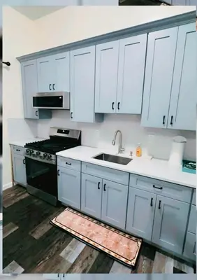 a kitchen with white cabinets and a sink and a stove at Bright Spacious 3-Bed Ideal, Sightseeing & Comfort in Elizabeth
