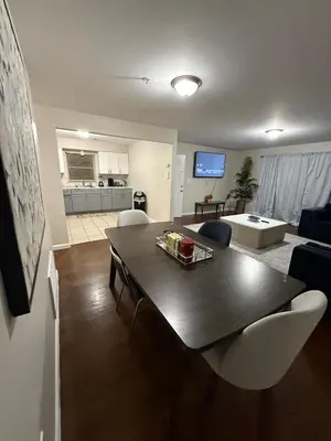 a living room with a table and a living room at COZY 3 bedroom APT near EWR Downtown NYC in Newark