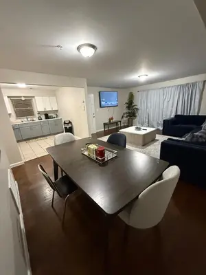 a living room with a table and a couch at COZY 3 bedroom APT near EWR Downtown NYC in Newark