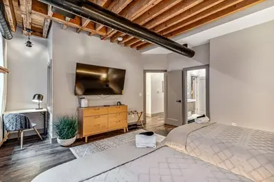 a bedroom with a large bed and a flat screen tv at Designer 5Bed - 4Bath Home in Old City A Plus Location in Philadelphia