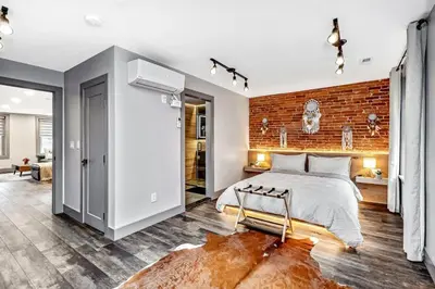 a bedroom with a brick wall and a bed at Designer 5Bed - 4Bath Home in Old City A Plus Location in Philadelphia