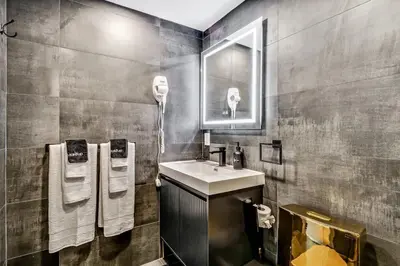 a bathroom with a sink and a mirror and towels at Designer 5Bed - 4Bath Home in Old City A Plus Location in Philadelphia