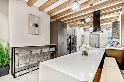 a kitchen with a large white table and chairs at Designer 5Bed - 4Bath Home in Old City A Plus Location in Philadelphia