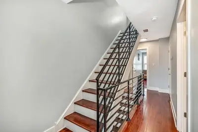 a staircase in a home with white walls and wooden floors at Outstanding Home Relaxing Rooftop with Patio & Grill in Philadelphia